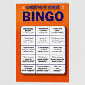 Front view of an orange and blue greetings card saying Customer Quote Bingo followed by an imitation bingo card of 15 common quotes that people in shops hear all the time by Retailer Therapy