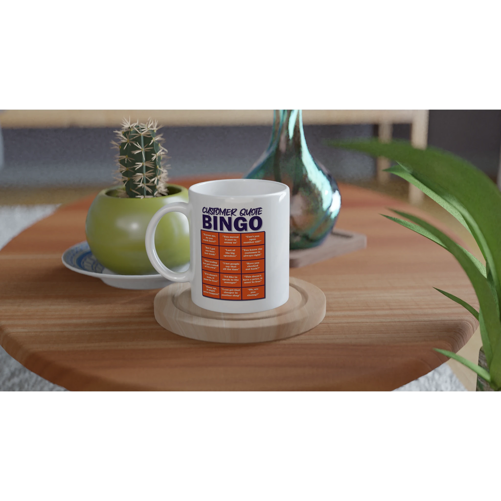 Lifestyle image of a white mug with an orange and blue design saying Customer Quote Bingo followed by an imitation bingo card of 15 common quotes that people in shops hear all the time by Retailer Therapy