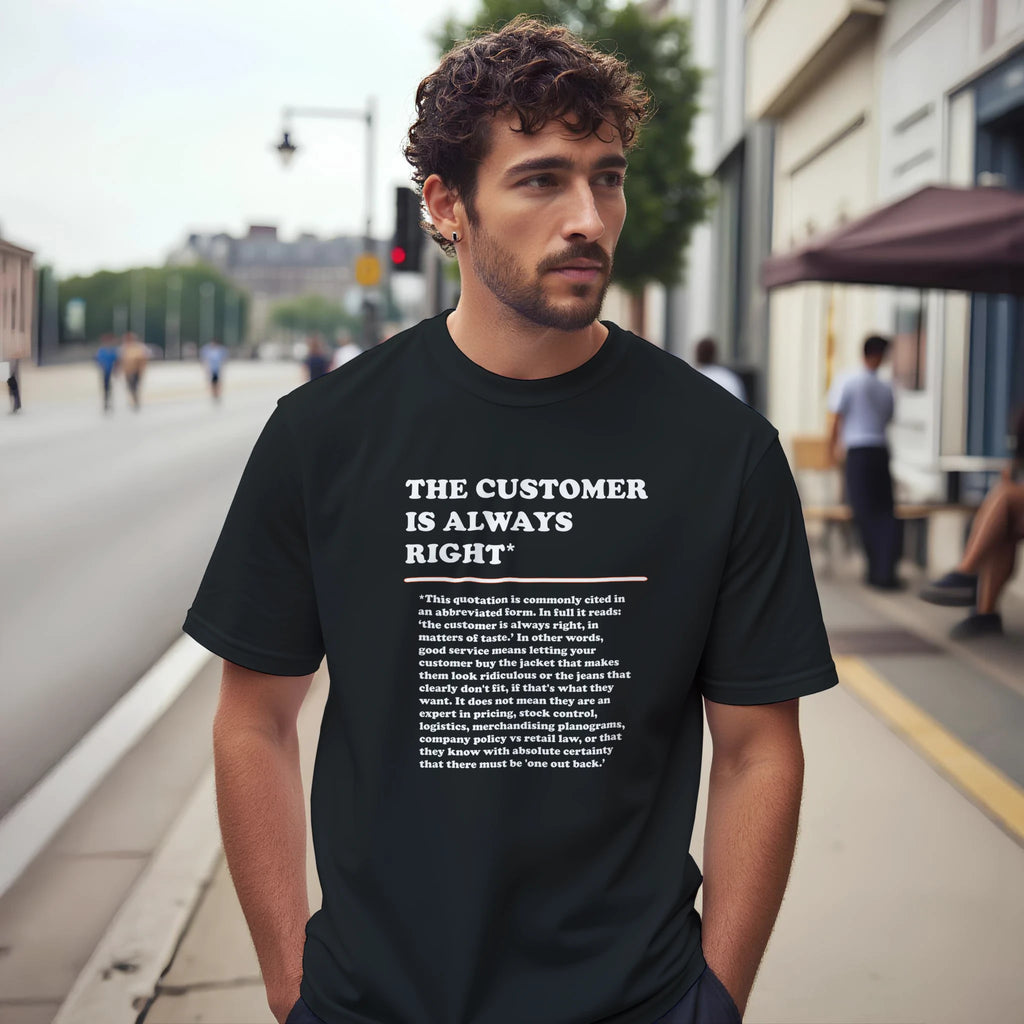 Lifestyle photo of a man wearing a black T-Shirt featuring the phrase "The Customer is Always Right*" with a humorous disclaimer explaining why the customer is not always right by Retailer Therapy.