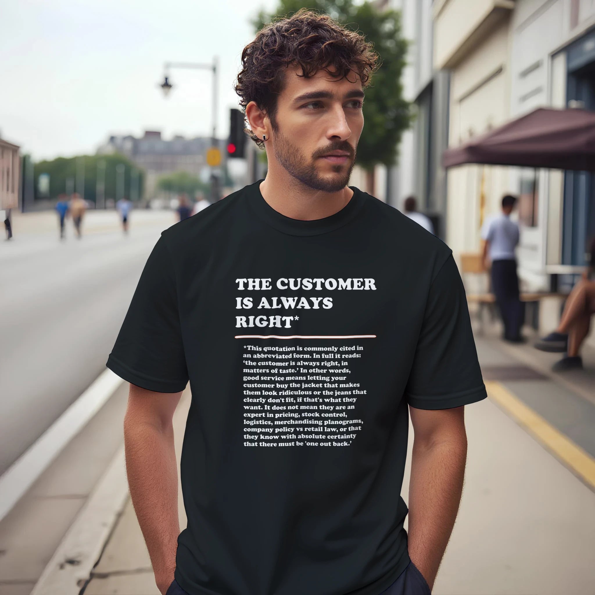 Lifestyle photo of a man wearing a black T-Shirt featuring the phrase "The Customer is Always Right*" with a humorous disclaimer explaining why the customer is not always right by Retailer Therapy.