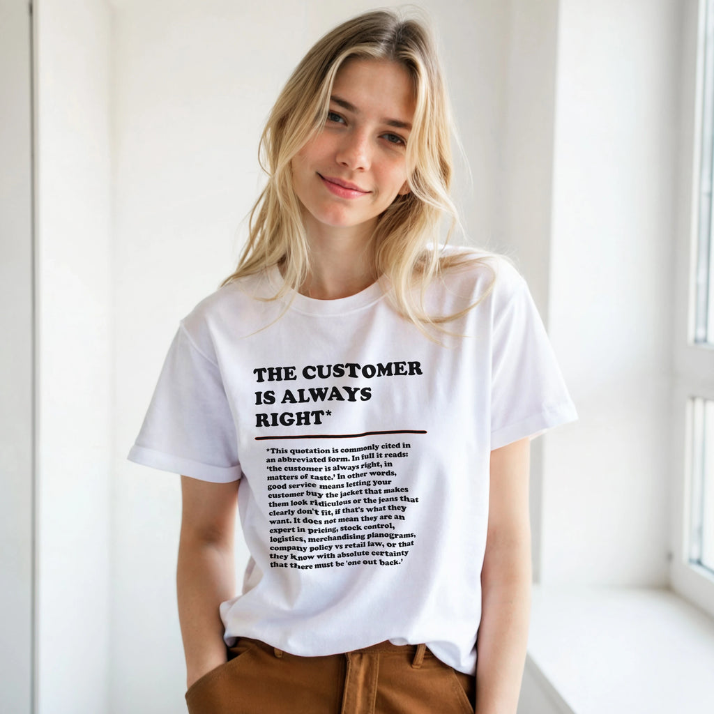 Lifestyle photo of a young woman wearing a white T-Shirt featuring the phrase "The Customer is Always Right*" with a humorous disclaimer explaining why the customer is not always right by Retailer Therapy.