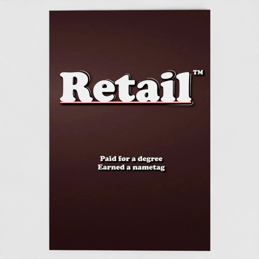 Front view of a grey greetings card featuring the phrase "Retail - Paid for a degree, Earned a Nametag' in a bold white typeface by Retailer Therapy.